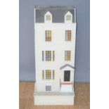 A large wooden dolls house, modelled as a four storey town house with electric lighting throughout