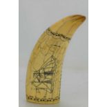 A Scrimshaw style engraved whale tooth, depicting a ship.