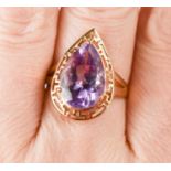 A 10ct gold and amethyst dress ring, the teardrop cut amethyst of approximately 15 by10.4mm within