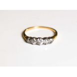 An 18ct gold and diamond five stone ring, largest central stone of approximately 3.7mm, size N, 2.