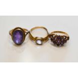 A group of three 9ct gold and amethyst dress rings, comprising an oval cut amethyst of 13.3 by 9.