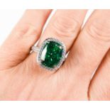 A Pariba Tourmaline and silver ring, the cushion cut 8ct tourmaline bordered by simulated
