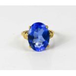 A 9ct gold and blue topaz dress ring, the oval cut stone of approximately 16 by 12mm, size P, 4.