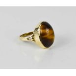 A 9ct gold and tigers eye oval cabochon ring, 4.5g.