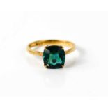 A 9ct gold and green tourmaline dress ring, the cushion cut stone of approximately 8.1 by 7.5mm,