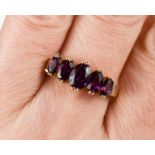 A 9ct gold and amethyst ring, with five graduated oval cut amethysts, size R, 3.1g.