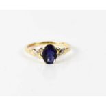 A 9ct gold, iolite and diamond ring, the oval cut iolite 8 by 5mm, size O½.