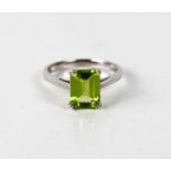 A 9ct white gold and peridot ring, rectangular cut.