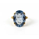 An aquamarine dress ring, the basket set, oval cut stone of approximately 17.8 by 12.8mm, shank