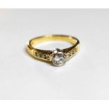 An 18ct gold and diamond ring, the centre stone approximately 0.25ct, and set with six further