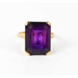 A 9ct gold and amethyst dress ring, the emerald cut stone of approximately 16.1 by 12.5mm, size Q,