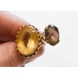 A 9ct gold ring set with an oval cut citrine, 18.1 by 13.5mm, size N, and another 9ct gold ring
