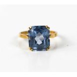 A 9ct gold and aquamarine dress ring, the faceted emerald cut stone of approximately 11.9 by 10.1mm,