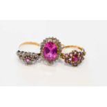 A group of three 9ct gold rings set with pink sapphires, comprisng a single oval cut stone of