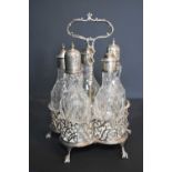 An early 18th century cruet condiment set, with five cut glass bottles, the tops inscribed oil,