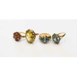 A group of four 9ct gold dress rings, comprising an oval cut citrine in beaded ribbon weave setting,