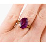 A 9ct gold and pink sapphire dress ring, the single oval cut stone of approximately 14.2 by 9.9mm,