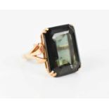 A 9ct gold and dark green quartz stone dress ring, the emerald cut stone of approximately 20 by