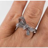 A silver bow knot pave ring, set with simulated diamonds, size O, 4.4g.
