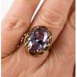 A 9ct gold and amethyst dress ring, the oval amethyst of approximately 13.8 by 10mm, size O, 3.96g.