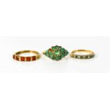 An Indian 10ct gold and emerald dress ring set with sixteen emeralds in flower design (a/f one