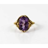 A 9ct gold and amethyst dress ring, the oval amethyst of approximately 13.5 by 9.5mm, size P, 3.