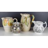 A group of four water jugs, one Sunderland lustre, one Victorian painted with lady and gent, and two