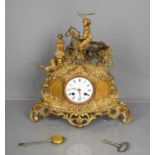 A 19th century gilt metal French mantle clock, with Roman numeral dial, surmounted by boy on