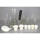 A group of vintage glass and ceramic measures of various sizes.