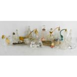 A quantity of antique glass perfume bottles with their stoppers, individual stoppers, atomisers,