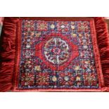 A quantity of small wool Middle Eastern rugs.