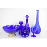 A collection of blue glass, comprising decanter and stopper, 32cm high, pedestal bowl, 26cm