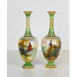 A pair of Royal Worcester bottle vases, painted with pheasants in an all round landscape, with