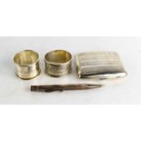 A silver cigarette case together with two silver napkin rings and a Johnson Matthey & Co Ltd