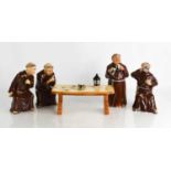 A set of Bretby pottery 'Jovial Monks', playing cards and drinking ale around a table.