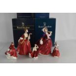 A group of Royal Doulton figurines comprising Flower of Love HN3970, Autumn Breezes HN1934, Emma