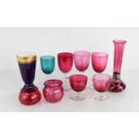 A group of cranberry glass wares, including a silver mounted stem vase with twist fluted stem the