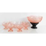 A pale pink glass bowl in the Lalique style decorated with fishes, 28cm diameter, with tiered