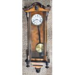 A 19th century mahogany Vienna wall clock, with Roman numeral dial, original pendulum, and a
