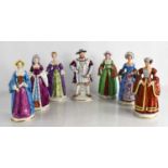 A set of Sitzendorf figures representing Henry VIII and his six wives, each standing on a titled