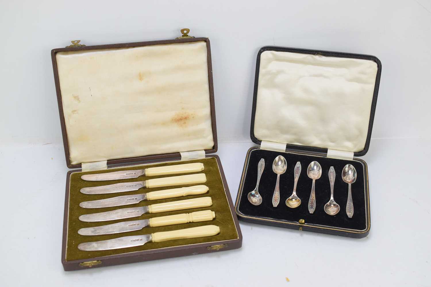 A cased set of six silver teaspoons together with a cased set of silver and bone handled knives.