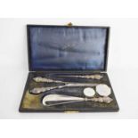 A silver handled dressing set comprising button hook, shoehorn in the original case.