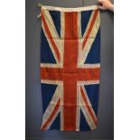 A vintage linen Union flag of separate panels of red, blue and cream, stitched together to form