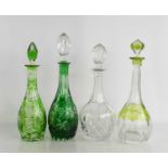 Four cut glass decanters of various form, three coloured examples, three with original stoppers.