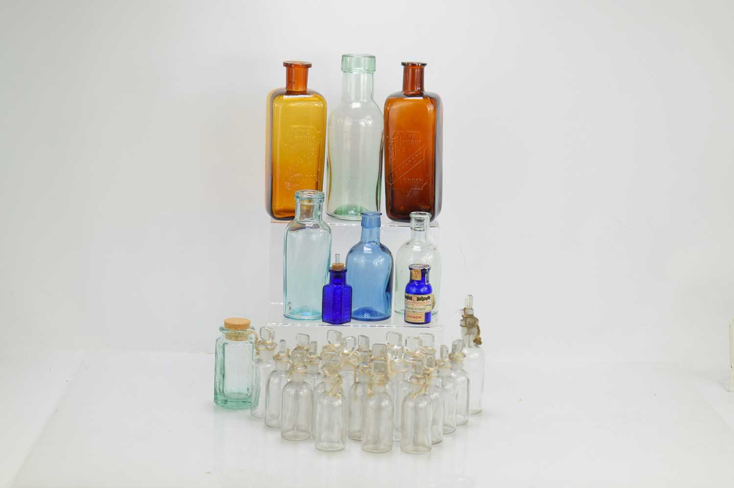 A group of medicine and other bottles to include a blue glass cocaine nitrate example and two Armour