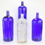 Three large blue glass poison bottles together with a clear glass example, the tallest measures