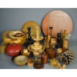 A group of treen to include bowls, candlesticks, boxes, vases and other items.