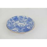 A Qing dynasty blue and white painted plate, decorated with figures on a bridge with pavilions and