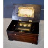 A 19th century Swiss music box, the rosewood case with a 6 inch cylinder playing 8 airs, and