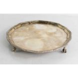 A silver salver, raised on four ball and claw feet, London, TB&S, with presentation inscription to